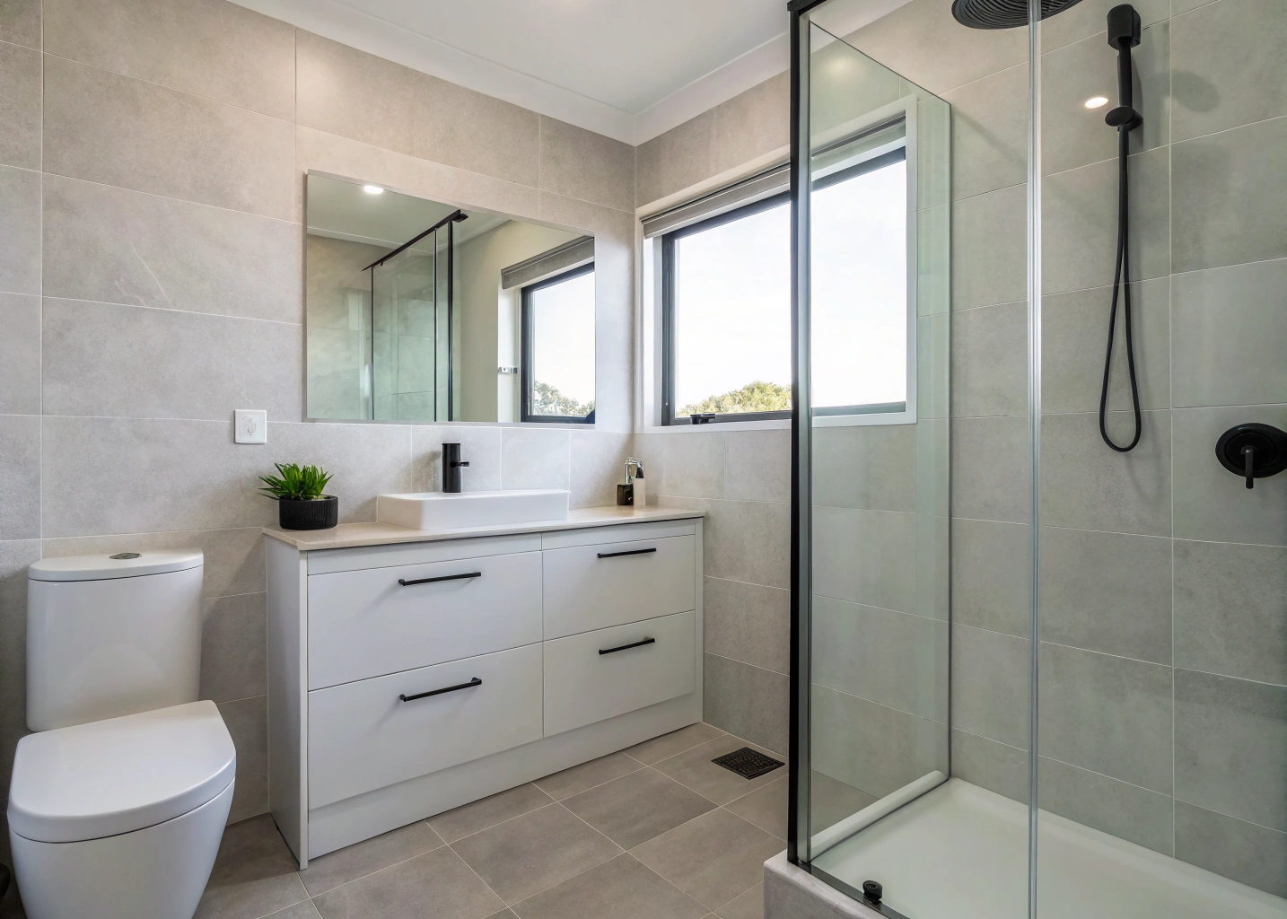 Renovated ensuite bathroom with large format tiles and wall-hung vanity, Wollongong